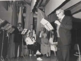 Concert performance with conductor — black and white